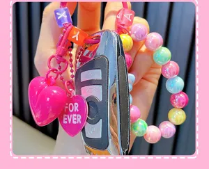 Close-up of acrylic colorful beaded keychain with pink heart charm and "FOR EVER" tag