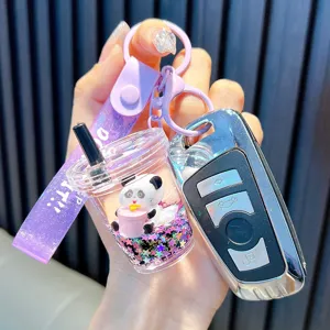 Cute cartoon panda liquid boba tea keychain with purple glitter strap and acrylic charms.