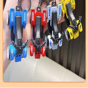 Detailed view of four colorful miniature ATV beach motorcycle keychains in a row