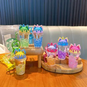 Cute cat ear milk tea cup keychain featuring liquid oil and colorful pearls, perfect for gifts.