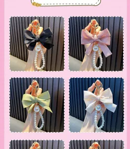 Detailed view of handmade pearl beading keychains with various colored fabric bows.