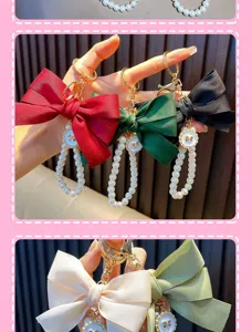 Detail view of colorful ribbon bow keychains with pearl beaded loops and gold charms.