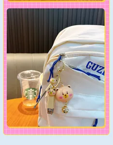 Cute animal themed portable nail clipper and ear pick keychain set shown on a backpack