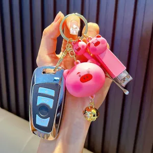 Portable cute pink pig nail clipper keychain set with a golden bell charm accessory