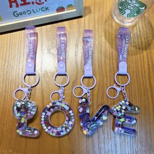 Transparent purple liquid quicksand letter LOVE keychains set with sparkling star sequins