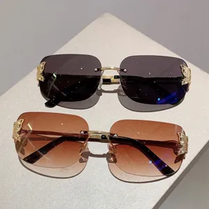 Close-up of retro rimless square sunglasses with elegant gold butterfly accents