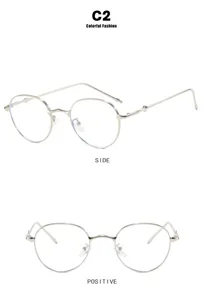 Detail view of small round silver metal sunglasses in minimalist fashion style for women