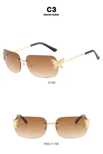 Detailed view of vintage rimless sunglasses featuring golden butterfly accents on lenses