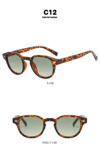 Una vista detallada de gafas de sol redondas de carey con lentes degradadas verdes