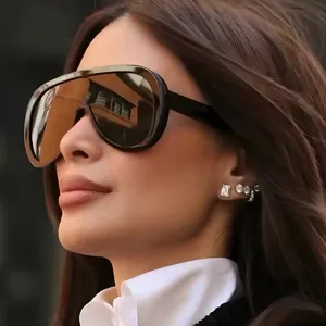 Close-up of oversized shield sunglasses with a sleek black frame and dark lenses.