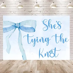 Blue watercolor bow bridal shower backdrop with She's tying the Knot text decoration