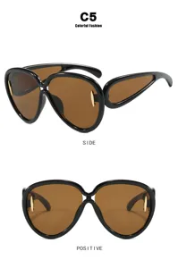 Futuristic oversized sunglasses for women in black frame with brown lenses view detail