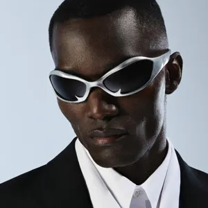 Close-up of futuristic Y2K silver sunglasses with a unique flame design frame for hip-hop style