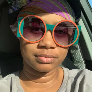 Close-up of trendy oversized green and orange geometric sunglasses for parties.