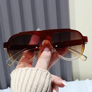 Close-up of trendy amber gradient aviator sunglasses for women's sun protection