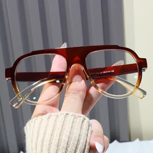 Detailed macro view of trendy oversized gradient amber aviator sunglasses for women