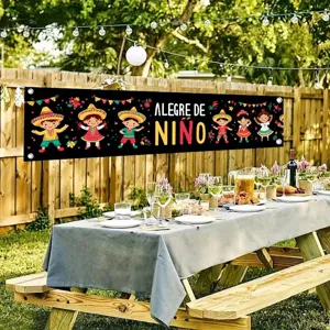 Colorful Mexican Children's Day banner hanging on a rustic garden fence for party decor