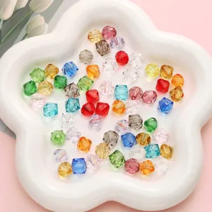 Close-up of 10mm faceted colorful crystal beads for DIY jewelry making on white plate