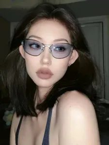 Close-up of retro futuristic metal cat-eye sunglasses worn by a stylish fashion model