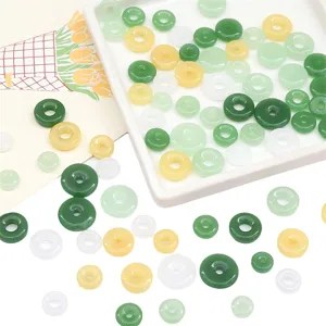 Close-up of glass imitation jade safety buckle beads in mixed green and yellow colors for DIY