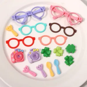 Detailed view of colorful miniature glasses frames, cameras, and clover DIY accessories