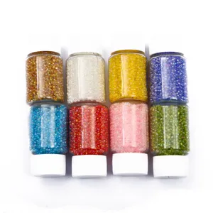 Macro view of eight small bottles filled with colorful 2mm glass seed beads for DIY jewelry