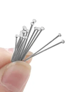 Detailed close-up of silver-colored round head T-pins for handmade jewelry making