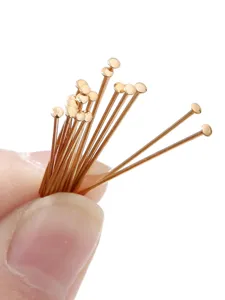 Close-up of gold-plated T-shape headpins for DIY jewelry making and earring design