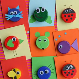 Detail view of colorful DIY animal crafts made with self-adhesive googly eyes and bottle caps