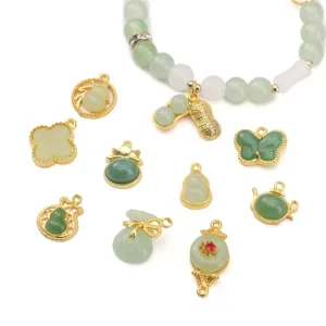 Detailed view of alloy imitation jade charms like gourds and butterflies for DIY jewelry.