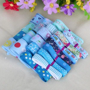 Variety of blue patterned grosgrain ribbons for DIY craft decoration and gift wrapping.