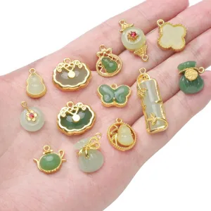 Close-up of various mini jade-style glass pendants for DIY jewelry making