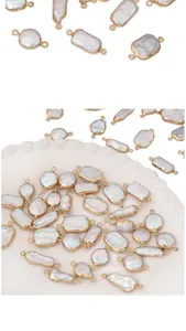 Close-up of irregular natural freshwater pearl pendants with gold double loop borders for DIY.