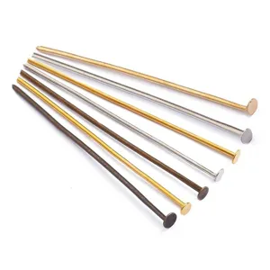 Detail macro view of various metallic T-head pins for DIY jewelry making accessory findings.