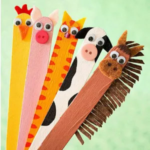 Close-up of black and white wiggle eyes on colorful DIY animal popsicle sticks