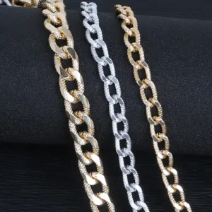 Detailed view of textured gold and silver aluminum curb chains for DIY jewelry making.