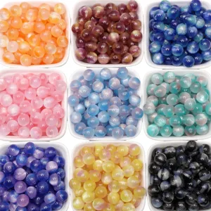 Close-up of colorful gradient glitter beads for DIY jewelry making in various shades.