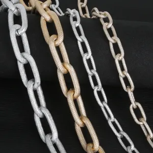 Close-up of gold and silver aluminum chains with textured links for DIY jewelry.