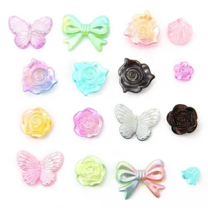 Detailed view of colorful gradient pearl DIY charms in butterfly, bow, and rose shapes