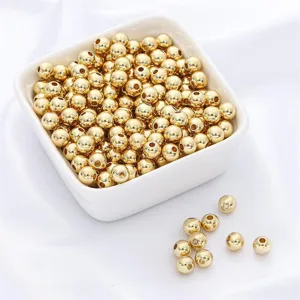 Macro detail view of shiny 14k gold-filled round spacer beads for DIY jewelry making