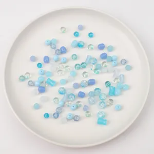 Close-up of assorted blue glass beads and jelly bamboo joint beads for DIY jewelry
