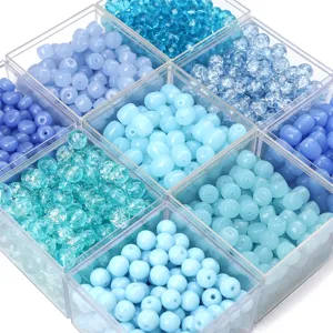 Macro view of blue glass and acrylic beads in various textures for DIY jewelry crafting