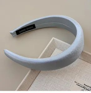 Detail shot showing the metallic silvery sheen and texture of a French wide padded headband
