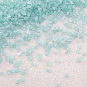 Close-up macro detail of mint green AB colorful crushed glass for DIY crafts filling