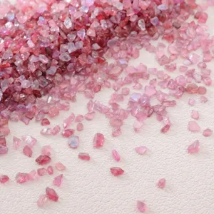 Close-up of pink iridescent crushed glass stone chips for DIY crafting and fillers