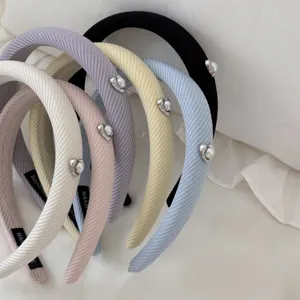 Set of assorted pastel headbands with elegant heart-shaped pearl details