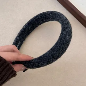 Macro detail of charcoal grey felt headband showing high quality plush fuzzy texture