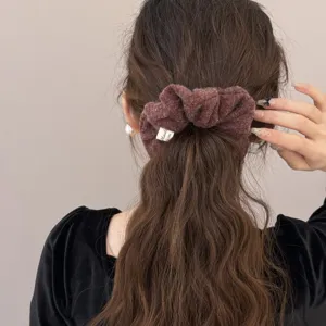 Soft brown felt plush scrunchie for women, elegant hair tie for ponytails and buns.