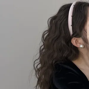 Korean style pink sponge headband with delicate black flower patterns on wavy hair