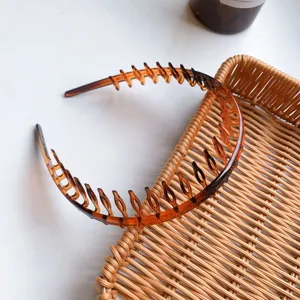 Macro detail of high-toughness amber plastic hair comb headband with long teeth